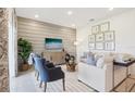 Cozy living room showcasing a neutral color palette, stylish furnishings, and a decorative accent wall at 921 Pearlwood Loop, Eagle Lake, FL 33839