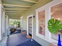 Inviting covered porch with beautiful natural light, seating and blue painted floor at 1000 Elmwood St, Orlando, FL 32801