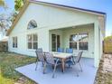 A covered patio offers outdoor seating for six, perfect for dining al fresco in the backyard at 101 Sandpebble Pl, Sanford, FL 32771