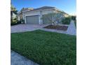 Beautiful home exterior features a lush lawn and well-maintained landscaping at 12184 Aztec Rose Ln, Orlando, FL 32827