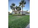 Attractive home with palm trees and manicured lawn, perfect for curb appeal at 12184 Aztec Rose Ln, Orlando, FL 32827