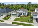 Well-maintained single-Gathering home with landscaped front yard, green lawn and inviting curb appeal at 17668 Passionflower Cir, Clermont, FL 34714