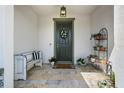 Inviting front porch features tile floors, bench seating and a decorated front door at 17668 Passionflower Cir, Clermont, FL 34714