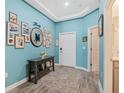 Inviting foyer featuring beautiful floors, custom wall decor, and a neutral-colored rug at 1807 Good Neighbor Loop, Kissimmee, FL 34744