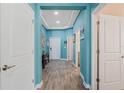 Hallway featuring beautiful floors, recessed lights and doors leading to rooms at 1807 Good Neighbor Loop, Kissimmee, FL 34744
