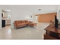 Open living space featuring neutral color palette, modern lighting, and access to the kitchen at 2240 Archer Blvd, Orlando, FL 32833