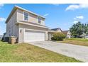 Charming two-story home featuring a two-car garage and a covered porch at 2723 Callaway Ln, Kissimmee, FL 34744