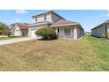 Charming two-story home featuring a two-car garage, a covered porch, and a well-maintained lawn at 2723 Callaway Ln, Kissimmee, FL 34744