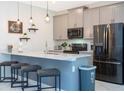 Well-lit kitchen featuring stainless steel appliances, pendant lights, and a breakfast bar at 2964 Protagonist St, Kissimmee, FL 34746