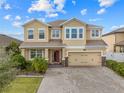 Stunning two-story home with a brick driveway, large garage and manicured lawn on a bright day at 3087 Somerset Park Dr, Orlando, FL 32824