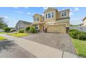 A beautiful two-story home featuring a well-kept lawn, brick paved driveway, and a two-car garage at 3087 Somerset Park Dr, Orlando, FL 32824