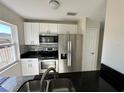 Updated kitchen featuring stainless steel appliances, granite countertops, and white cabinetry at 3513 Westland Dr, Orlando, FL 32818
