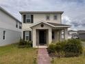 Two-story home with manicured lawn, brick pathway, and beautiful front garden at 3954 Great Smokey Way, Apopka, FL 32712