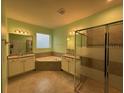 A bright bathroom features dual vanities, a soaking tub, and a separate glass-enclosed shower at 4036 Parkhouse Dr, Orlando, FL 32824