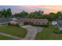 Charming single-story home featuring a large driveway and mature landscaping at 4231 Yorketowne Rd, Orlando, FL 32812