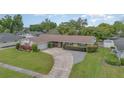 Lovely single-story home featuring a large driveway and well-manicured lawn at 4231 Yorketowne Rd, Orlando, FL 32812