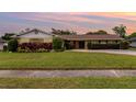 Charming single-story home with mature landscaping and well-maintained lawn at 4231 Yorketowne Rd, Orlando, FL 32812