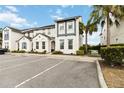 Modern townhome with neutral paint, blue accents, palm trees, and parking at 482 Captiva Dr, Davenport, FL 33836