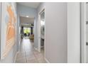 Hallway that leads to the living room, powder bath, and outdoor patio at 482 Captiva Dr, Davenport, FL 33836