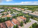 An aerial view captures this neighborhood's scenic setting, surrounded by verdant trees and serene water features at 5412 Solterra Cir, Davenport, FL 33837