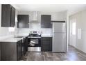 Modern kitchen featuring stainless steel appliances and dark cabinets at 5870 Cypress Shores Ct, Orlando, FL 32839