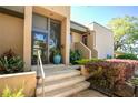 Stylish front entrance featuring a modern door, stairs and neatly trimmed landscaping at 601 W Old Us Highway 441 # 9B, Mount Dora, FL 32757