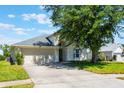 Charming home featuring a well-manicured lawn, two-car garage, and attractive landscaping at 7911 Magnolia Bend Ct, Kissimmee, FL 34747