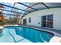 Beautiful pool featuring clear blue water, a screened enclosure and patio at 7911 Magnolia Bend Ct, Kissimmee, FL 34747