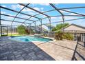 Inviting screened-in pool area, featuring a beautiful pool, patio and decorative water feature at 7911 Magnolia Bend Ct, Kissimmee, FL 34747