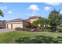 Beautiful home with a well-maintained lawn and landscape, paired with a spacious three-car garage and tiled roof at 801 San Raphael St, Poinciana, FL 34759