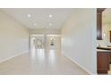 Bright and open living room featuring tile floors and recessed lighting, creating an inviting atmosphere at 801 San Raphael St, Poinciana, FL 34759