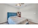 A serene bedroom features a comfortable bed, complemented by a ceiling fan and soft lighting at 8043 Brookeshire Dr, Lakeland, FL 33809