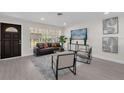 Bright living room with large windows, modern furnishings, and stylish decor for comfortable living at 822 Oakview Dr, New Smyrna Beach, FL 32169