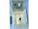 Bright two-story foyer boasts tile floors, white walls and a view to the living area at 871 Blairmont Ln, Lake Mary, FL 32746