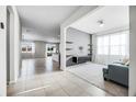 Bright, open-concept living room featuring tile flooring and neutral paint at 970 Glazebrook Loop, Orange City, FL 32763