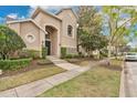 Charming home exterior with well-maintained landscaping, a paved walkway, and a serene setting at 7404 Oconee St, Reunion, FL 34747