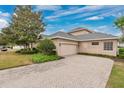 Spacious home with a brick-paved driveway leading to an attached two-car garage at 7404 Oconee St, Reunion, FL 34747