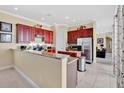 Well-equipped kitchen with stainless steel appliances, granite countertops, and ample cabinet space at 7404 Oconee St, Reunion, FL 34747