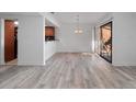 Bright living area with wood-look flooring, modern light fixture, and sliding glass doors at 1092 E Michigan St # 1, Orlando, FL 32806