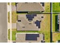 Aerial shot shows a home with solar panels installed on the roof in a neighborhood setting at 1174 Tupelo Trl, Haines City, FL 33844