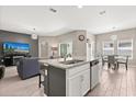 Open-concept kitchen featuring a large island with granite countertops and stainless steel appliances at 1174 Tupelo Trl, Haines City, FL 33844