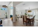 Bright and airy living room with high ceilings, an open floor plan, and beautiful wood floors at 1188 Brampton Pl, Lake Mary, FL 32746