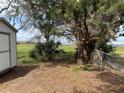 This property offers a spacious, fenced backyard with mature trees and shed for extra storage at 1328 Highland Cir, Kissimmee, FL 34744