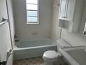 Bright bathroom features a bathtub with shower, toilet, vanity, and medicine cabinet at 1328 Highland Cir, Kissimmee, FL 34744