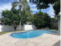 Backyard featuring a private pool, paved patio, lush trees, and a pristine white fence at 170 Lady Susan Ct, Casselberry, FL 32707