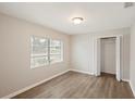 Cozy bedroom featuring wood-look flooring, a window, and a closet at 1704 15Th St, Orange City, FL 32763