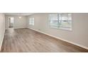 Spacious living room with attractive wood-look flooring and plenty of natural light at 1704 15Th St, Orange City, FL 32763