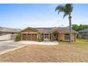 Charming single-story home with a two car garage, solar panels, and a welcoming front patio and lawn at 1969 La Rue Ave, Deltona, FL 32725