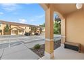 Exterior view from the covered entrance, showing well-kept complex buildings and parking area at 2608 Roadster Ln, Kissimmee, FL 34746