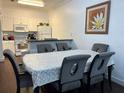 Open dining room featuring modern table and chairs, open to kitchen with white cabinetry at 2964 Lucayan Harbour Circ # 106, Kissimmee, FL 34746